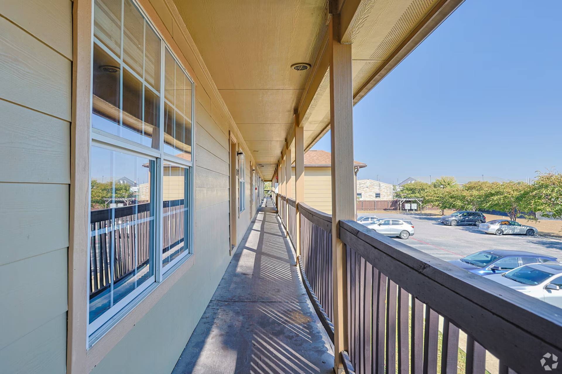 Second-floor breezeway and railing overlooking the parking court